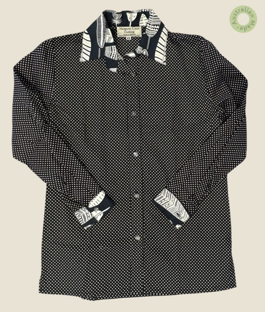 #402 – A classic black base shirt with an all-over white micro-dot print. The design fe