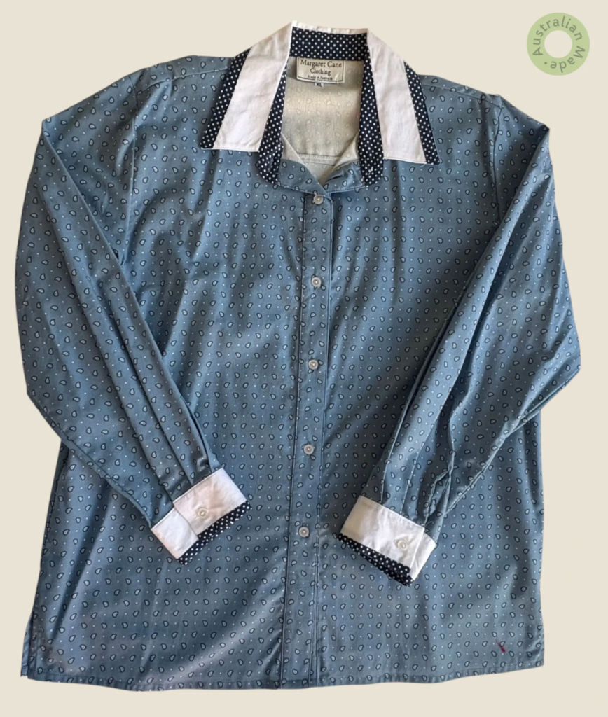 #223 – This shirt features a lightweight slate-blue base decorated with a uniform white