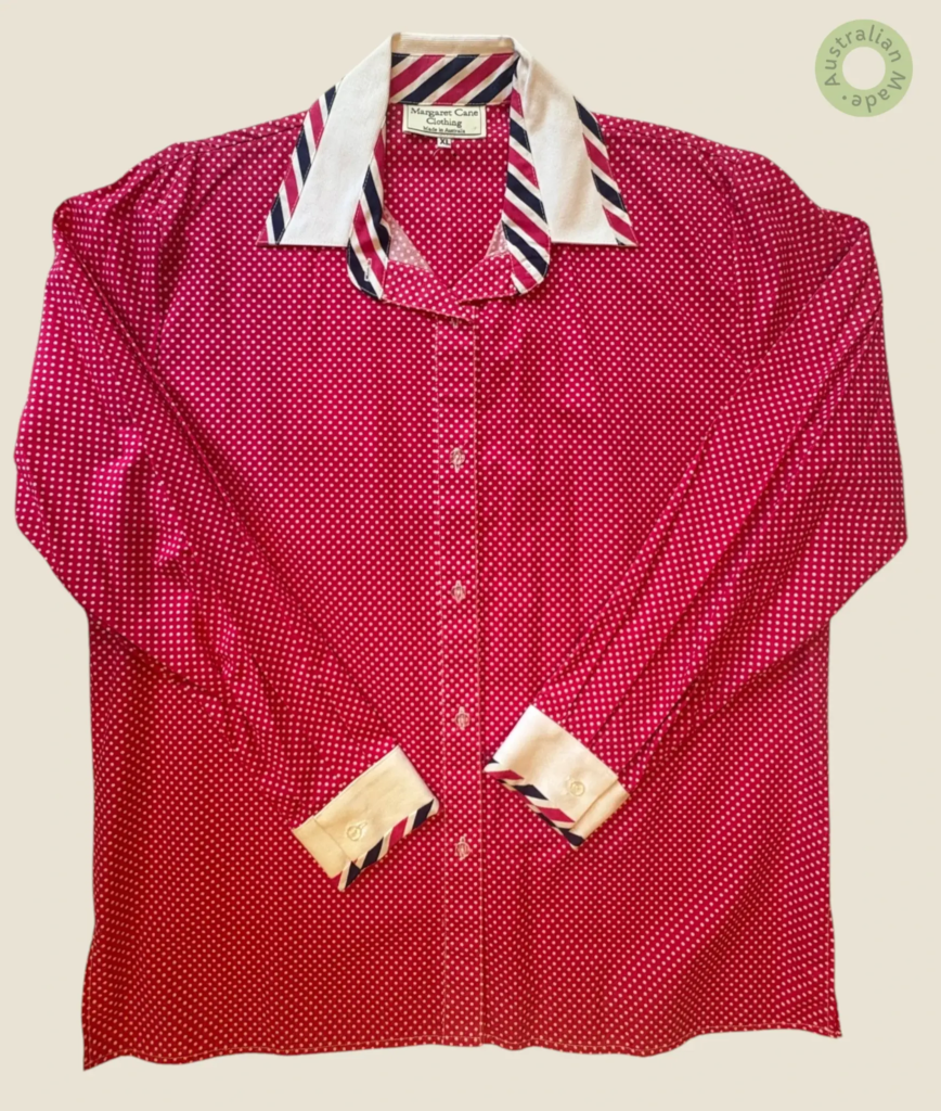 #229 – This shirt is crafted from a lightweight fabric in a distinct dark pink hue, fea