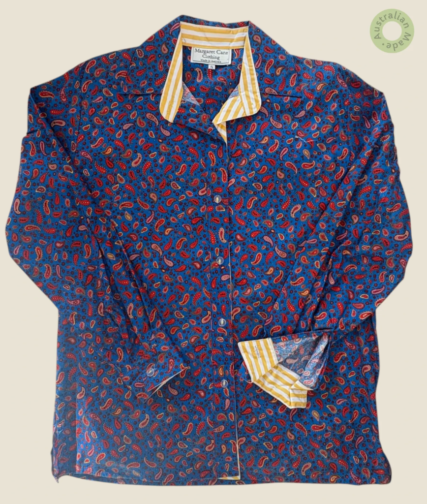 #410 – This professional shirt is crafted from a blue fabric featuring an all-over red