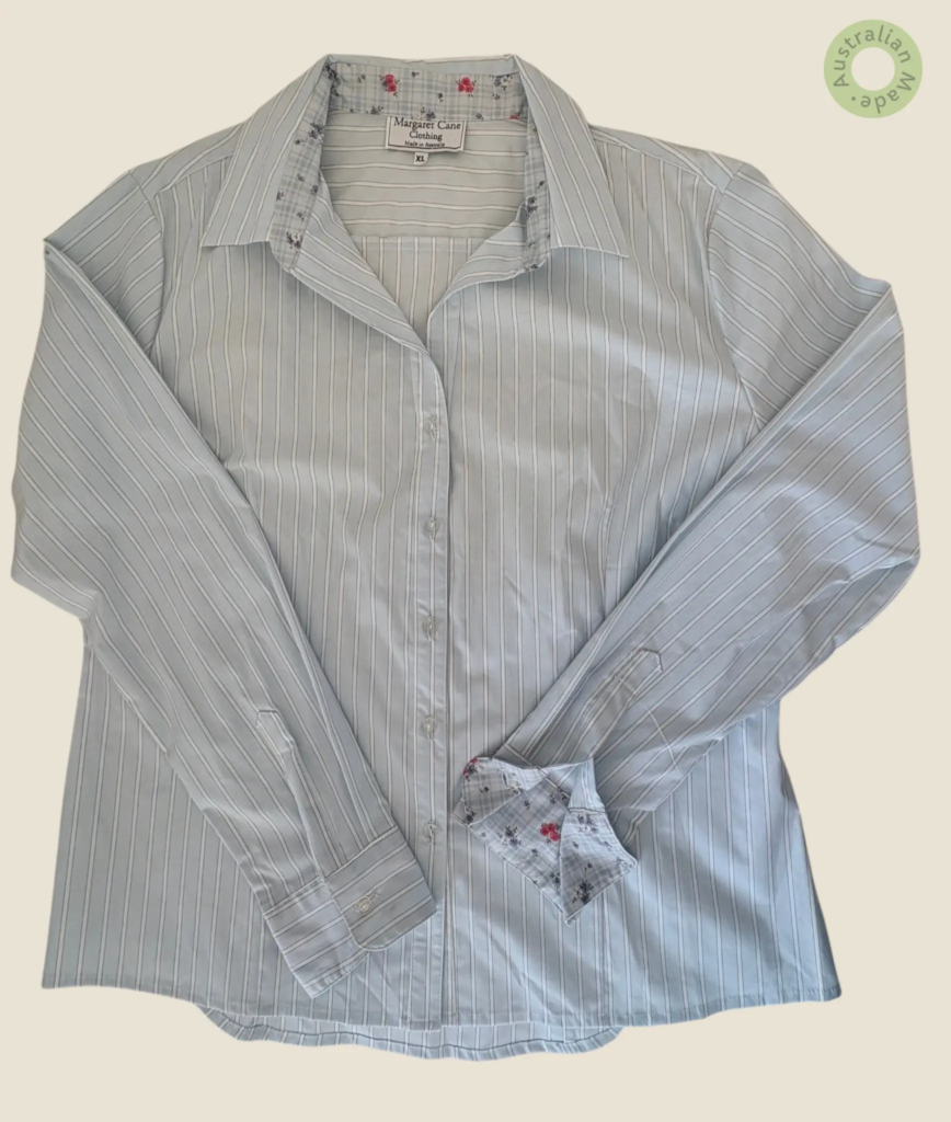 #504 – This professional shirt features a pale blue base with subtle horizontal white a