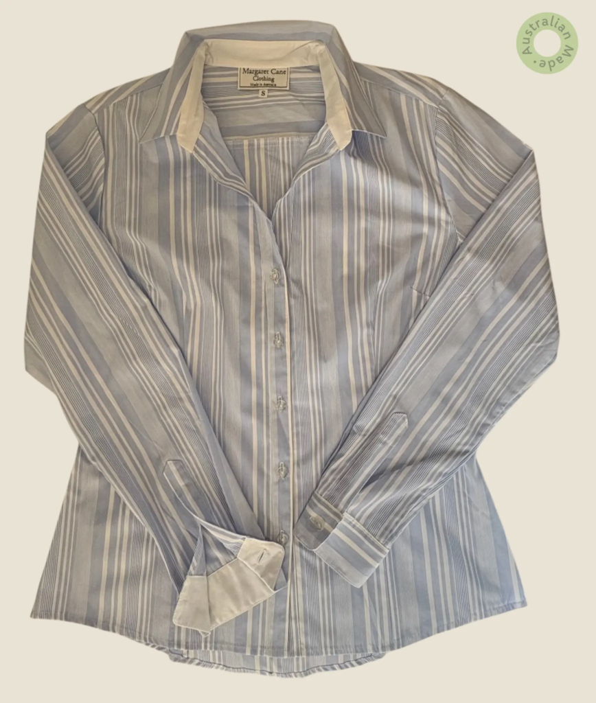 #505 – This professional shirt features a varied vertical stripe pattern in light blue
