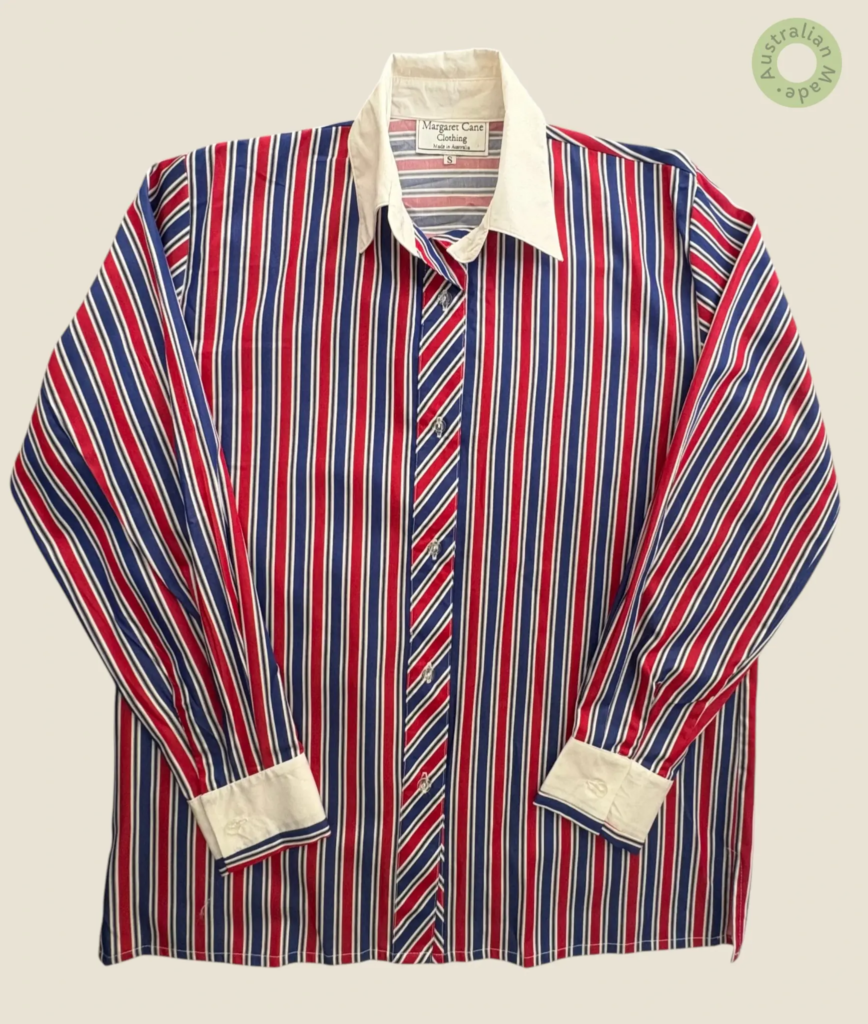 #409 – This professional shirt features a bold vertical stripe pattern in red, navy blu