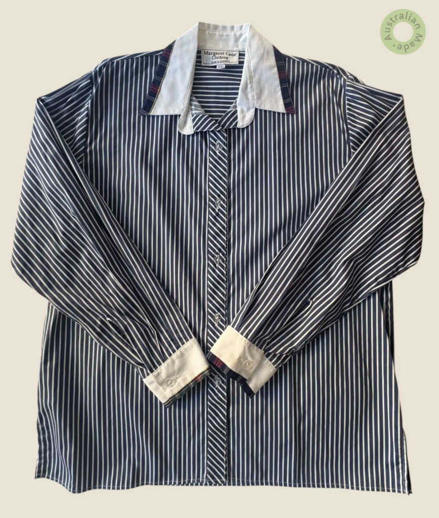 #239 – This shirt features a classic navy blue and white vertical stripe pattern, with