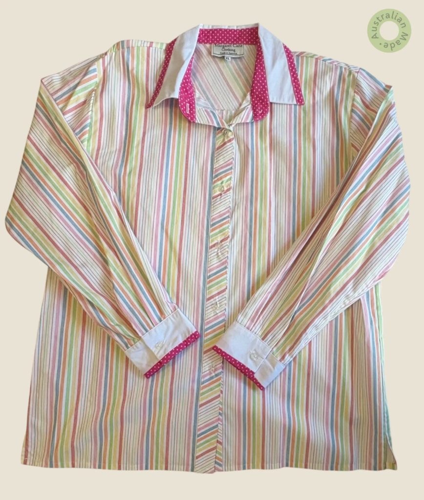 #240 – This shirt features a vibrant vertical stripe pattern in shades of coral, amber,