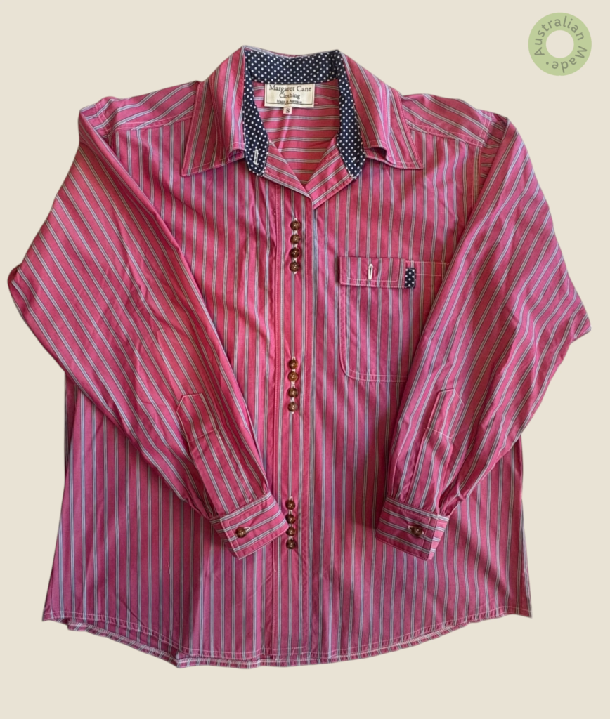 #120 – This shirt features a raspberry pink base with a vertical stripe pattern in navy