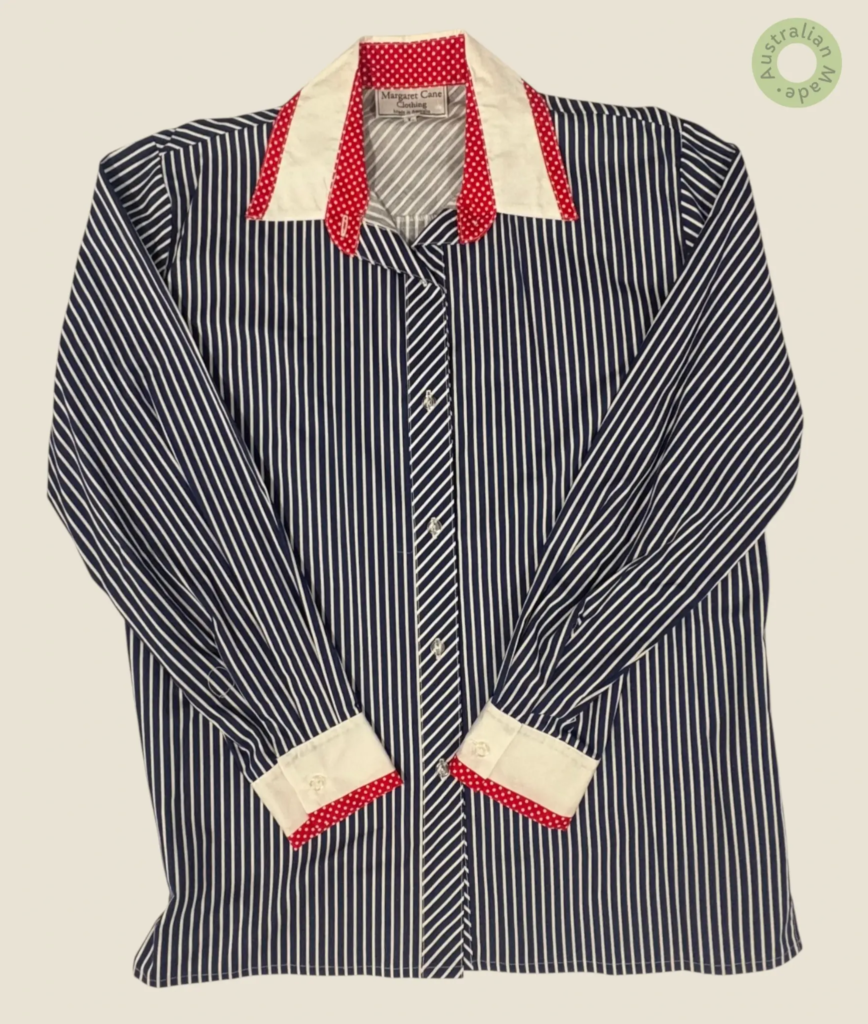 #246 – This shirt features a navv and white vertical stripe pattern on the main body an
