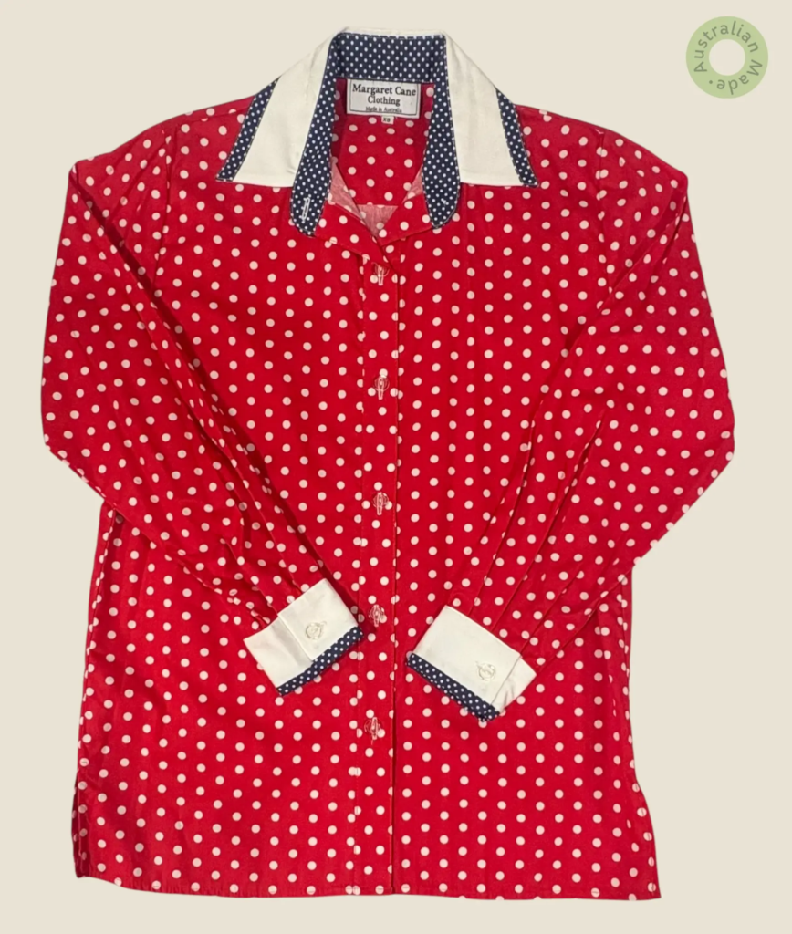 #241 – This shirt features a vibrant red and white polka dot pattern throughout the bod