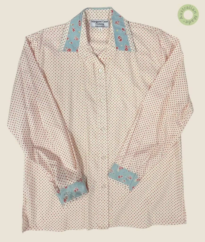 #243 – This shirt features a cream base with a red polka dot pattern throughout the bod