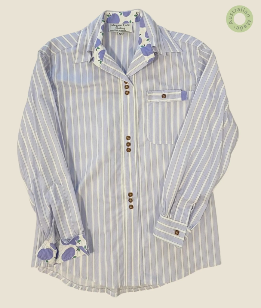 #132 – This shirt features a lilac and white vertical stripe pattern on the main body,