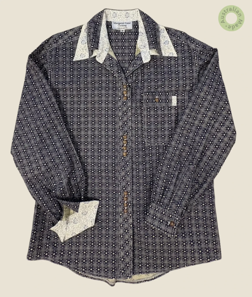 #134 – This shirt features a navy and white geometric pattern of star-filled medallions