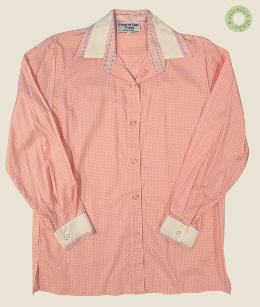 #248 – This shirt features a pink base with a small white polka dot pattern throughout