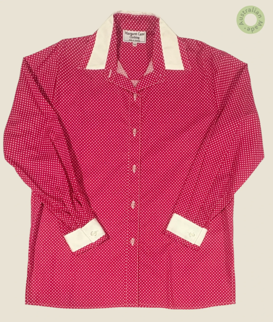 #256 – This shirt features a pink base with a white micro-polka dot pattern throughout