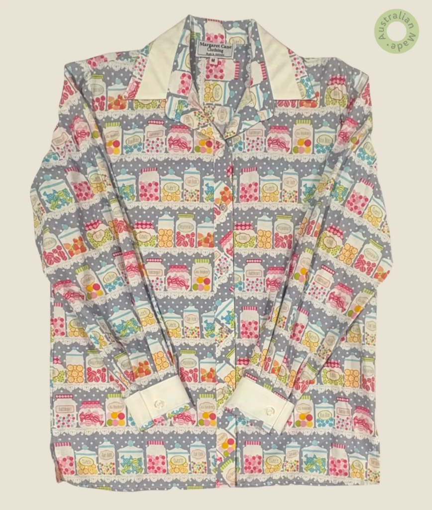 #257 – This shirt features a whimsical all-over print of colorful candy jars arranged i