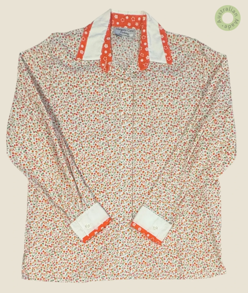 #259 – The Floral Orange Contrast Edge Shirt features a white base with a dense micro-f