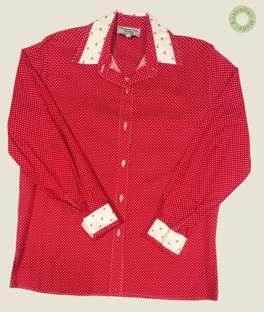 #260 – This shirt features a vibrant red base with a white micro-polka dot pattern thro