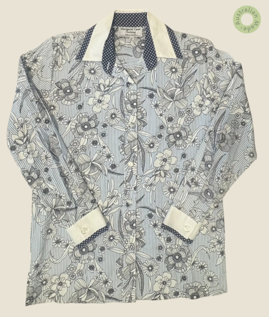 #268 – This shirt features a light blue and white vertical striped base overlaid with a