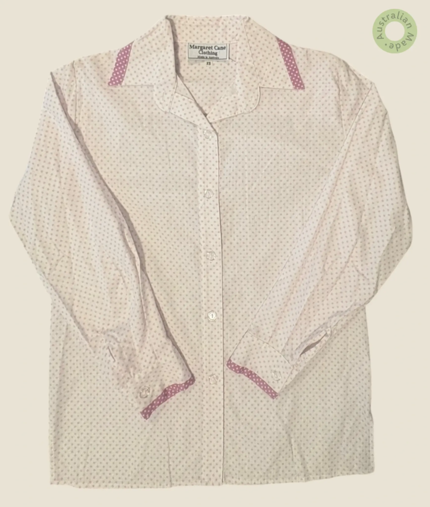 #269 – This shirt features a white base with a dense pink micro-polka dot pattern throu