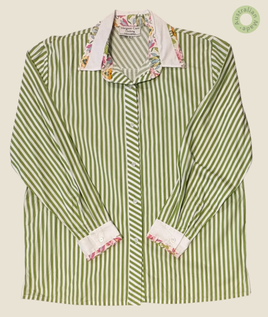 #276 – This shirt features a vibrant apple green and white vertical striped pattern thr