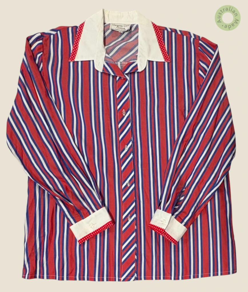 #277 – This shirt features a bold vertical striped pattern in red, blue, and white thro
