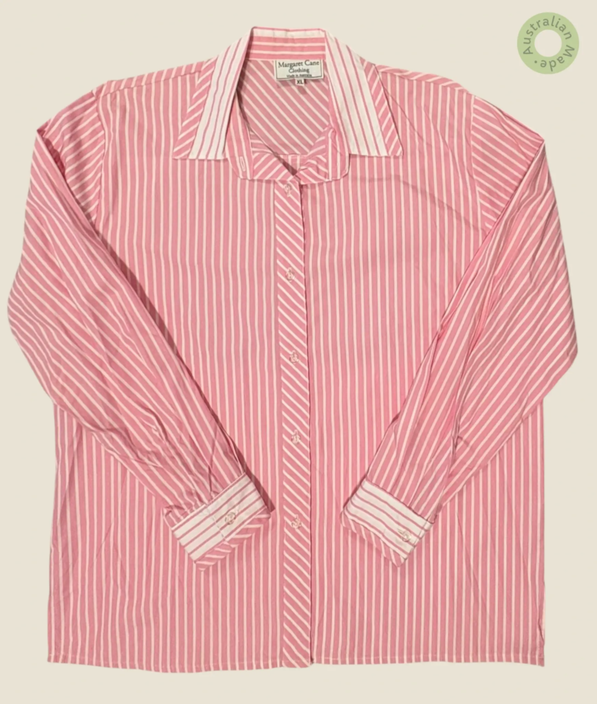 #279 – This shirt features a vibrant pink base with white vertical stripes throughout t