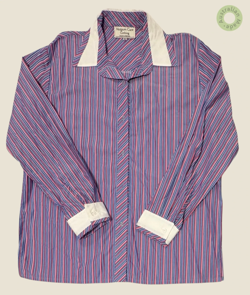 #280 – This shirt features a vibrant pink base with white vertical stripes throughout t