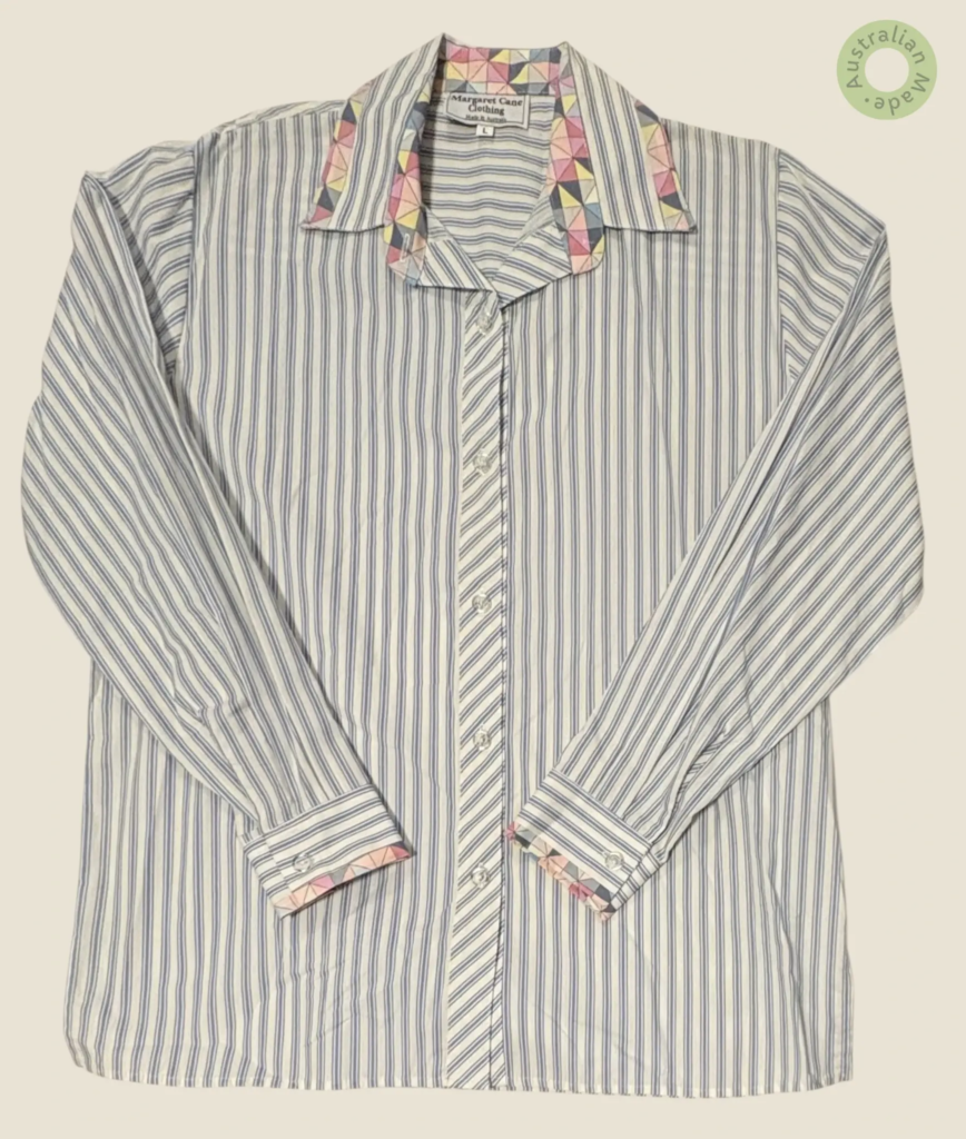 #281 – This shirt features a white base with fine blue vertical pinstripes throughout t