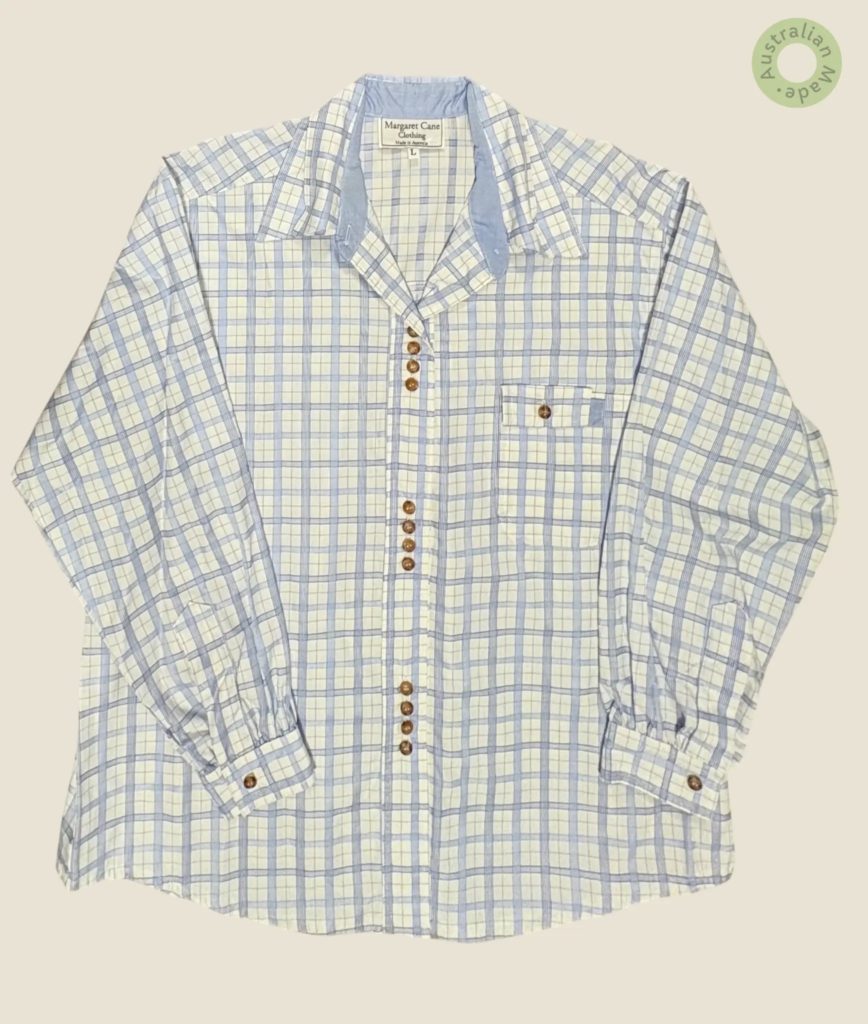 #139 – This shirt features a white base with a light blue windowpane check pattern thro