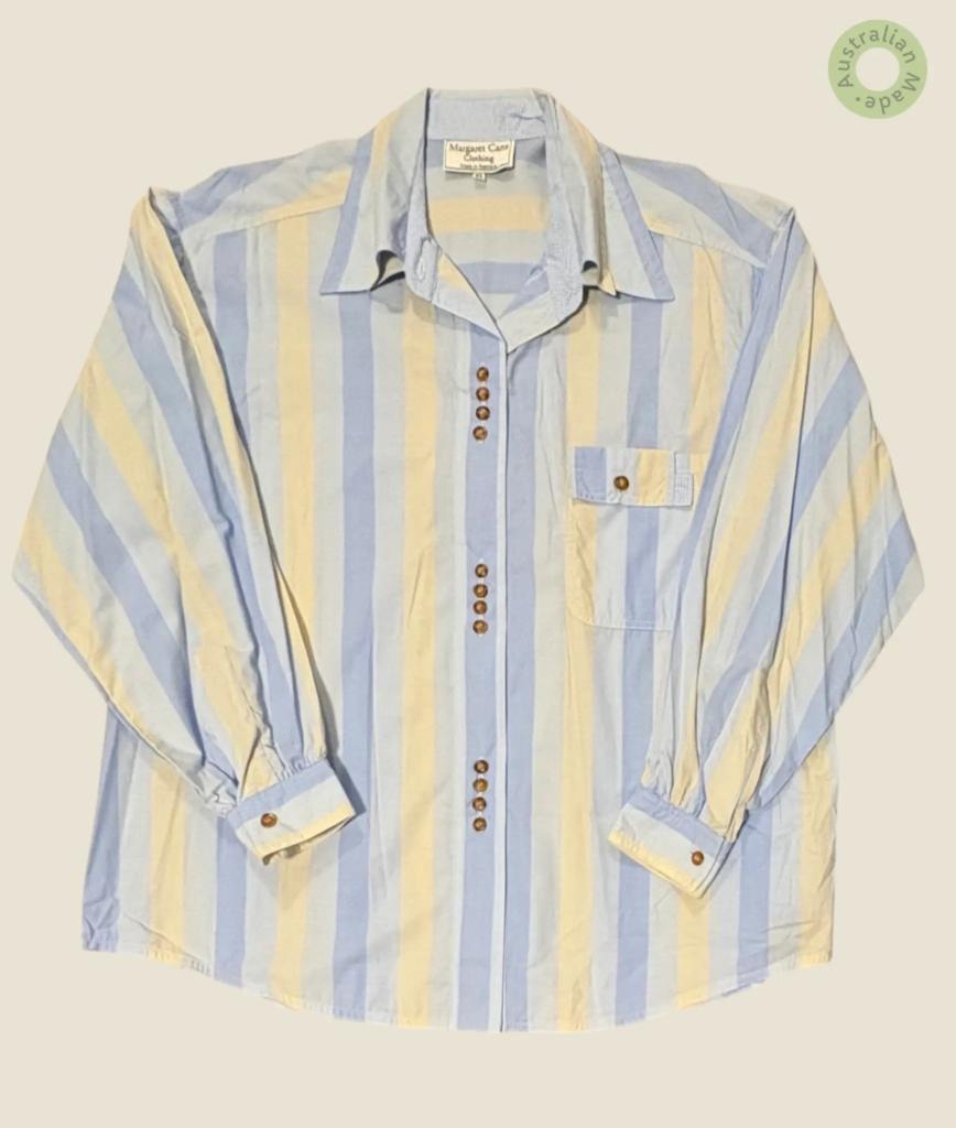 #141 – This shirt features a vertical wide-striped pattern in pale blue, soft yellow, a