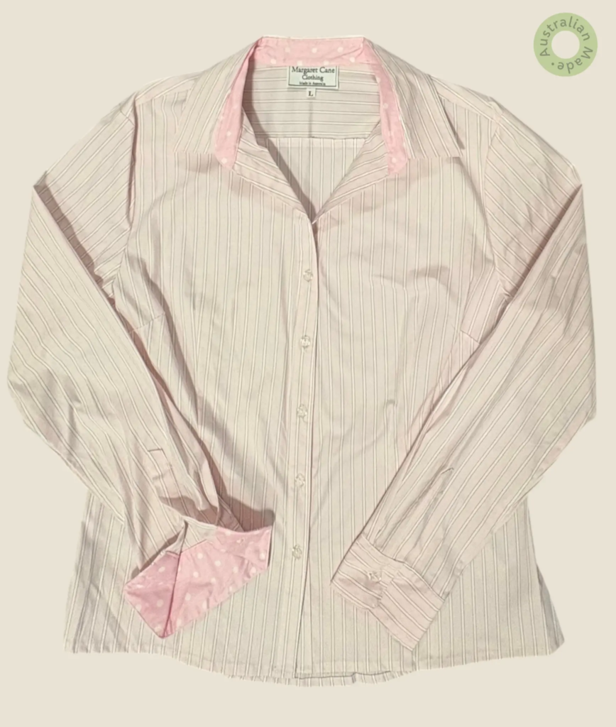 #510 – This shirt features a pale pink base with thin white vertical pinstripes through