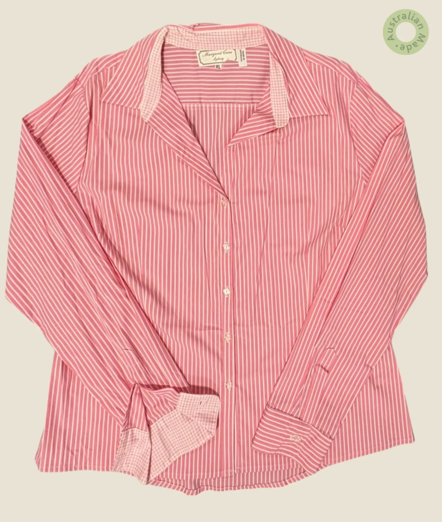 #511 – This shirt features a vibrant pink base with white vertical stripes throughout t