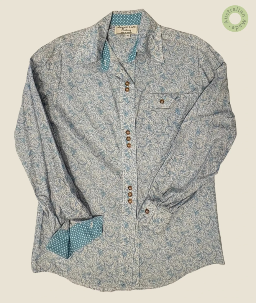 #143 – This shirt features a white base with an intricate teal and light blue paisley p