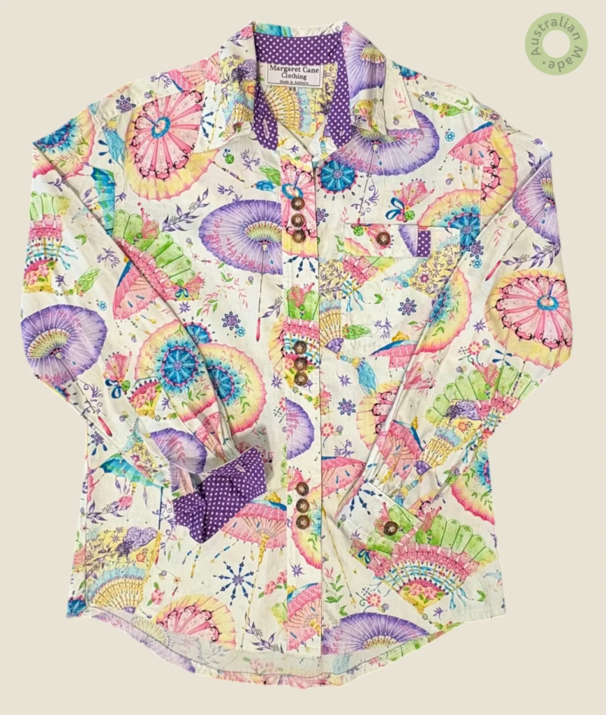 #144 – This shirt features a white base with a vibrant, all-over oriental parasol and f
