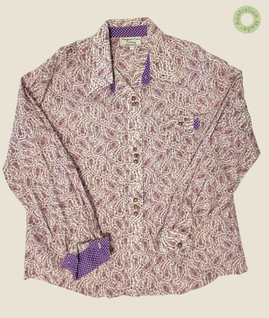 #145 – This shirt features a white base with a dense, all-over floral print in shades o