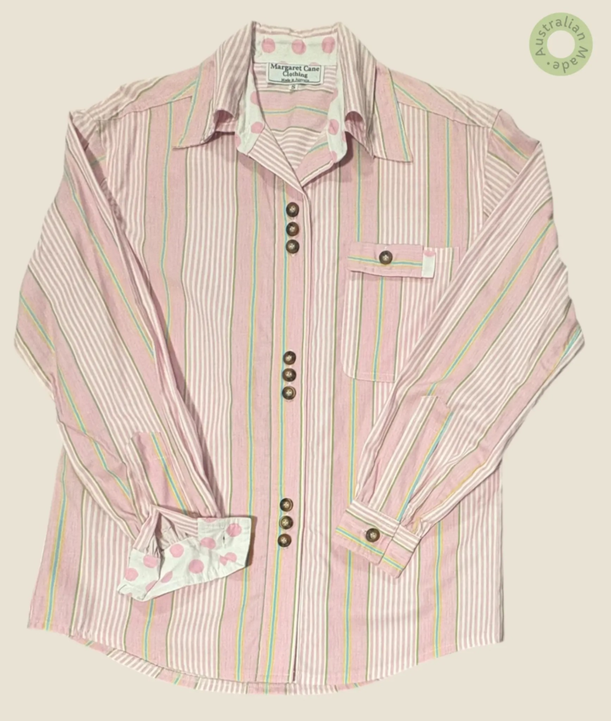 #146 – This shirt features a pink and white vertical stripe base with vibrant yellow an