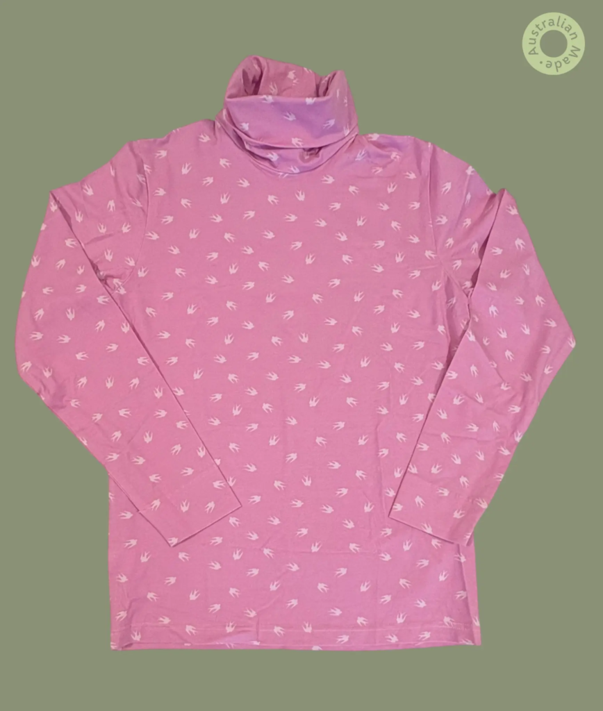 #601 – This top features a soft pink base color with a repeating white bird silhouette