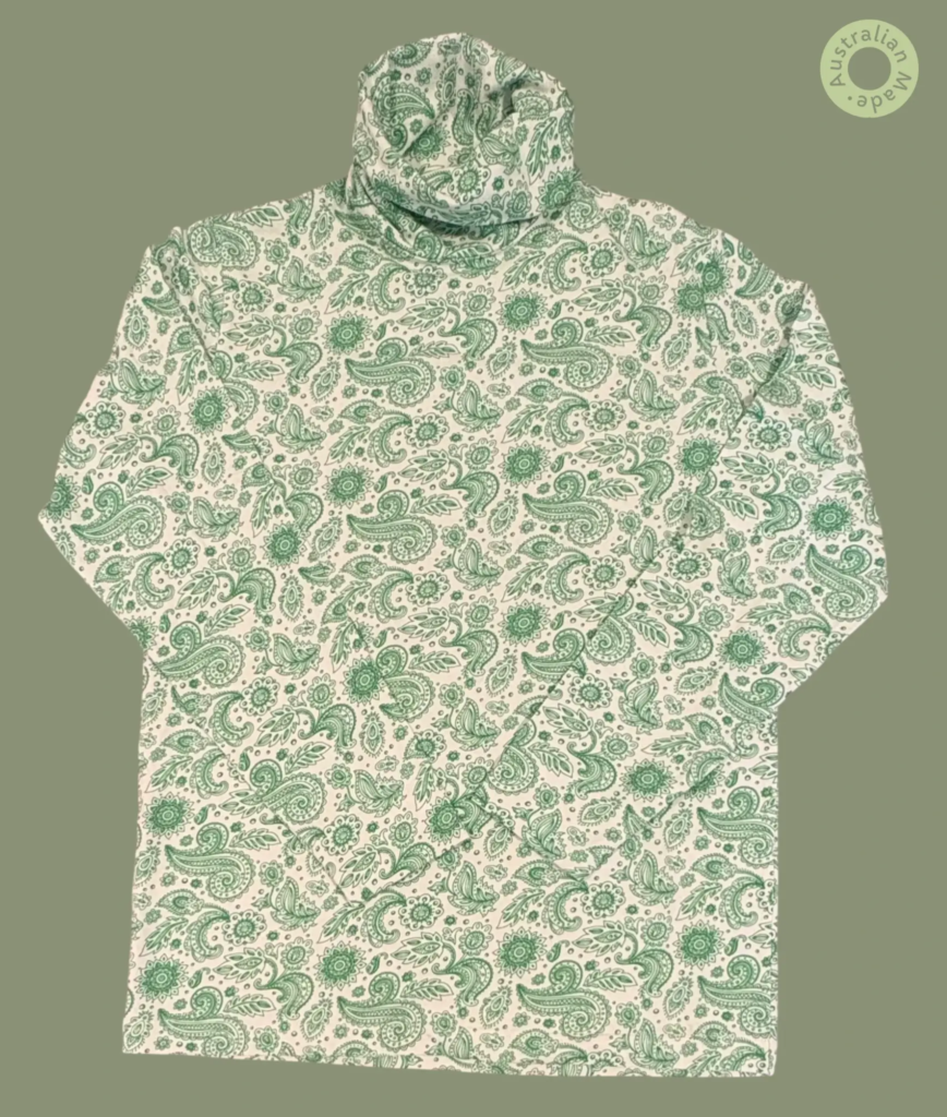 #602 – This top features a white base with a detailed green paisley and floral pattern