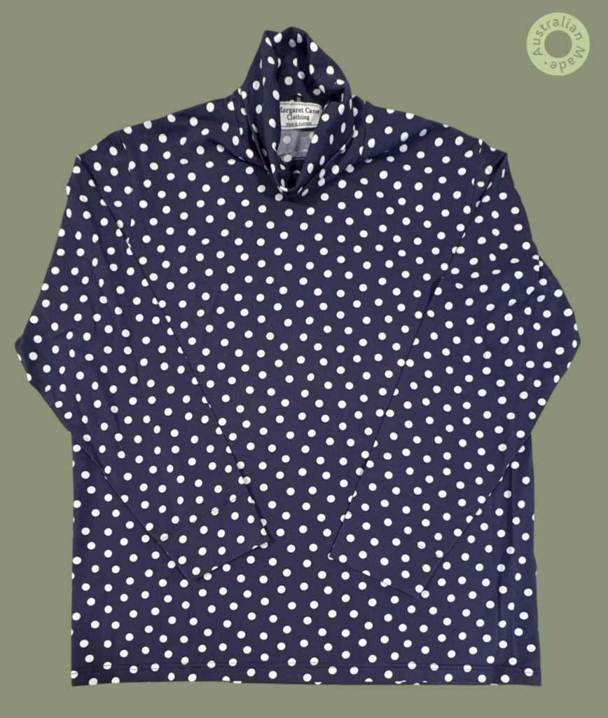 #608 – This top features a navy base with a white polka dot pattern throughout the body