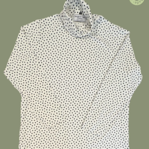 #609 – This top features a white base with a small navy polka dot pattern throughout th